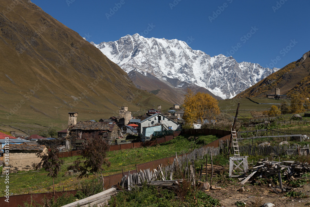 View of the village of Ushguli in a beautiful autumn landscape with white clouds in Svaneti. Georgia