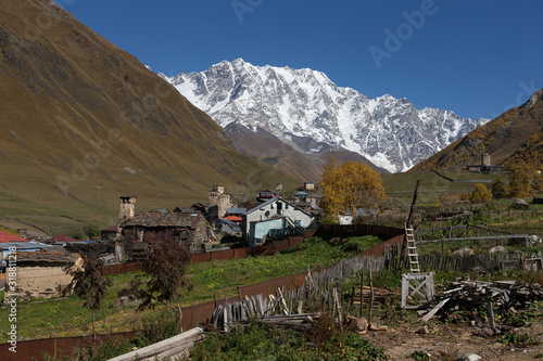 View of the village of Ushguli in a beautiful autumn landscape with white clouds in Svaneti. Georgia