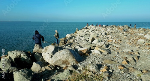 people catch fish on the Yeisk Spit photo