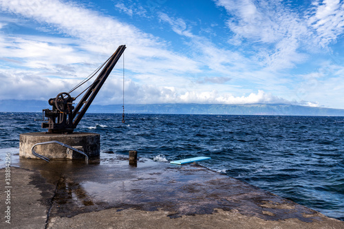 A crane on a boat ramp with Sao Jorge island in the distance on Pico in the Azores.