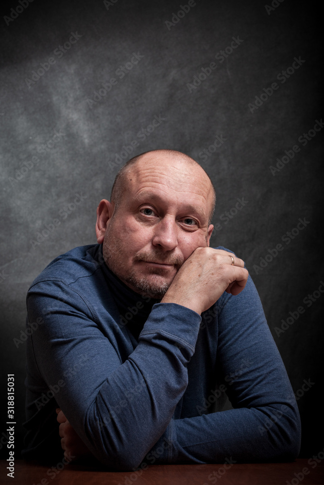 portrait of a middle-aged man on a dark background. reverie portrait of a middle-aged man on a dark background. reverie