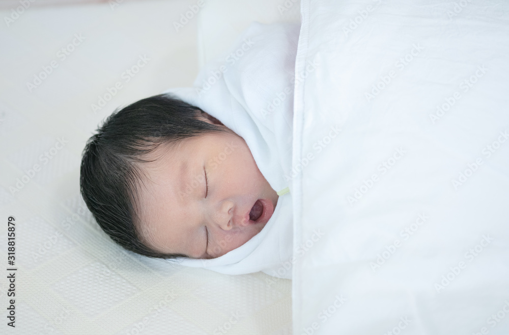 Closeup a baby sleeping comfortably on the bed Closeup a baby sleeping comfortably on the bed