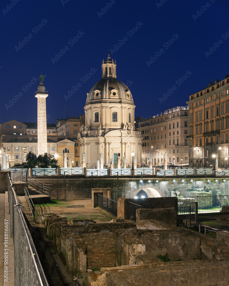 Rome, Italy - Dec 15, 2019: Rome, Italy. The church Most Holy Name of Mary and the Roman Triumphal Column at twilight on Trajan Forum