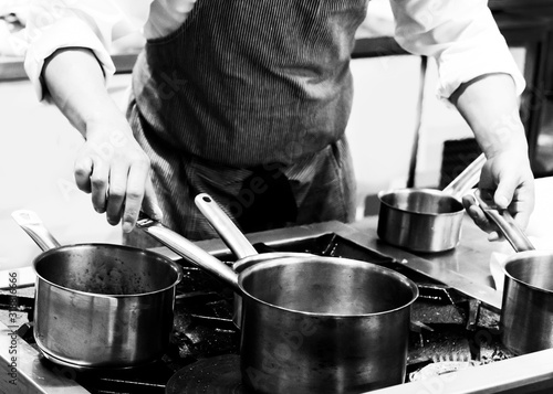 Chef cooking in a kitchen, chef at work, Black & White.