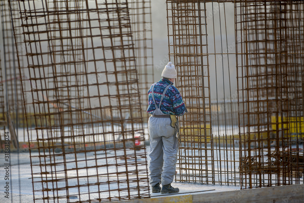 Man working at steel frames on a construction site Man working at steel frames on a construction site