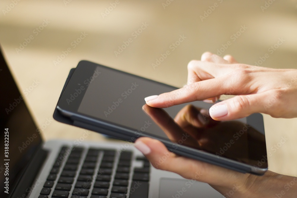 Woman hand clicks on digital tablet, closeup