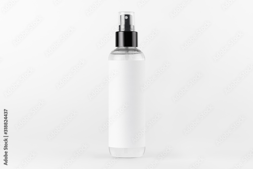 Tall transparent spray dispenser bottle for cosmetics product with white label on white background, mock up for branding, advertising, presentation, design. Tall transparent spray dispenser bottle for cosmetics product with white label on white background, mock up for branding, advertising, presentation, design.
