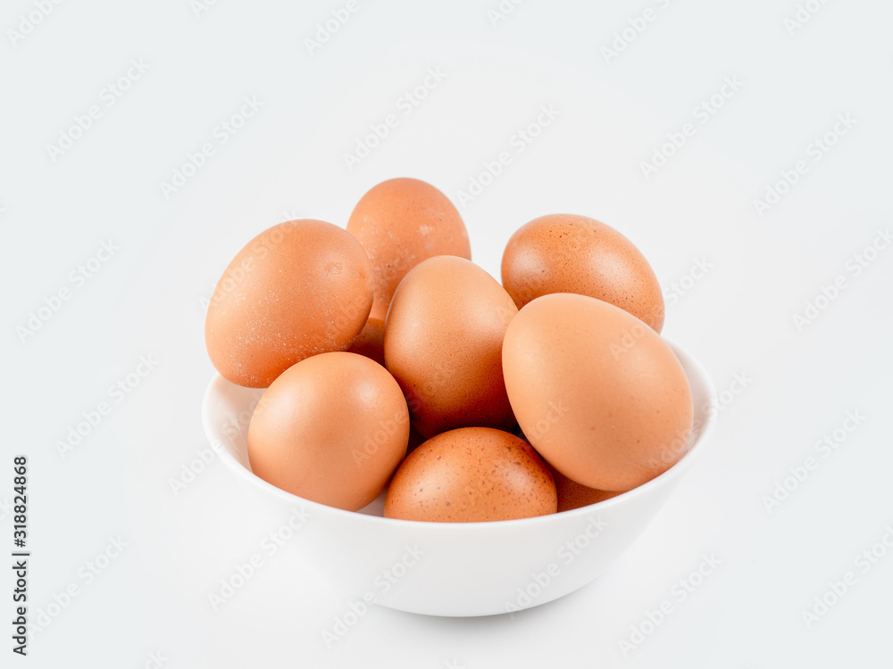Put eggs in one bowl on white background Put eggs in one bowl on white background