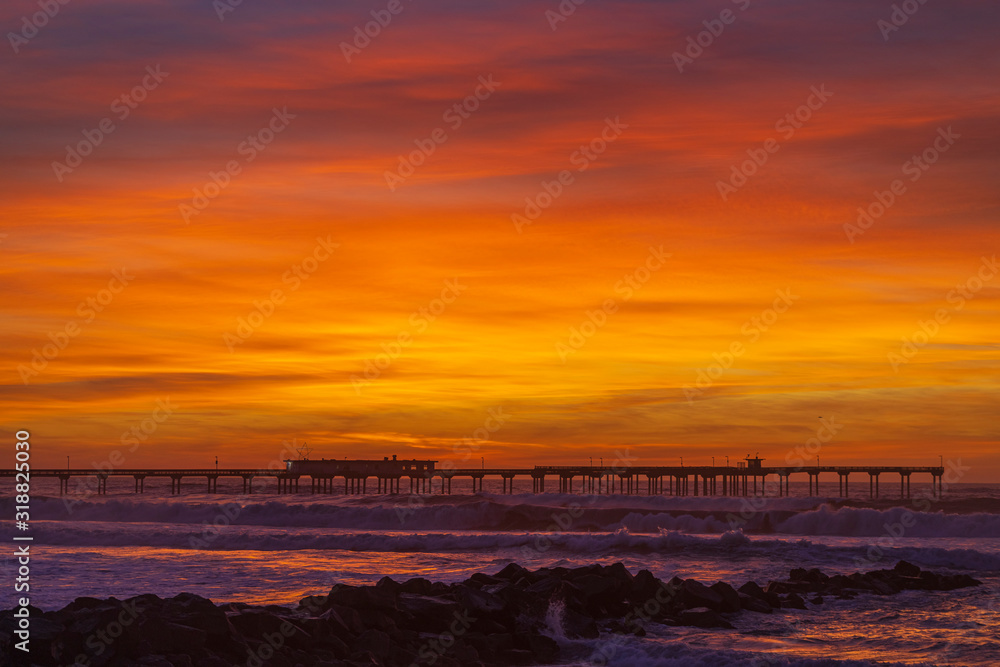 Nice colorful clouds after sunset at a pier over the Pacific Ocean. Ocean Beach neighborhood of San Diego, California. Nice colorful clouds after sunset at a pier over the Pacific Ocean. Ocean Beach neighborhood of San Diego, California.
