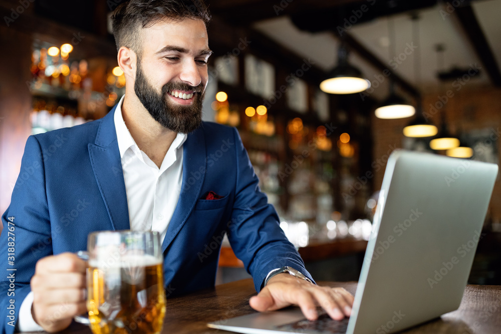 Handsome business man using laptop at his work break in restaurant