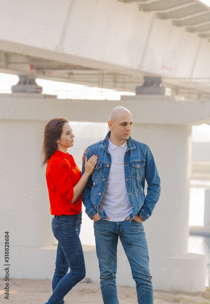 Happy lovers stand under the bridge on a sunny day. Happy lovers stand under the bridge on a sunny day.