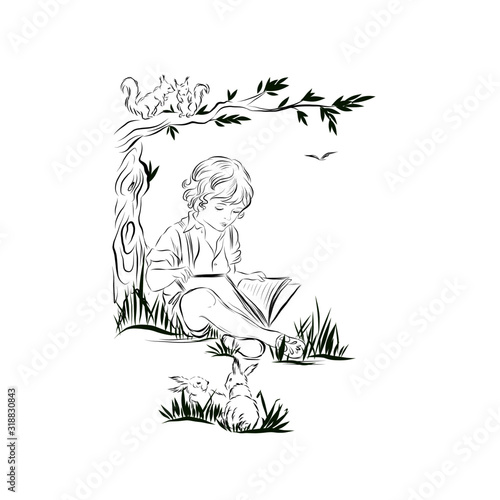 little boy reads a book while sitting on tree branches