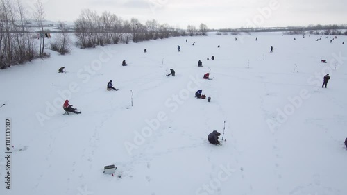 Fishermans on the ice. Competitions in fishing with jig from ice. Aerial view. photo