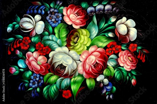 A tray painted with oil paints in the style of folk art crafts of Russia. Zhostovo painting. Acomposition of garden flowers on a black background.