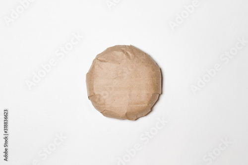 Classic Burger packed in the wrapping paper on white background. Top view. Hamburger Mock up.High resolution photo. © qoncha