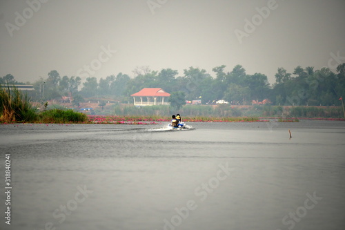 Udon Thani,Thailand-January 24, 2020: A boat returning to boatslip at Red Lotus Lake or Talay Bua Daeng in Udon Thani, Thailand photo