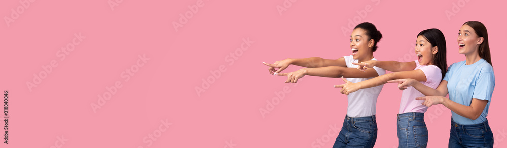 Three Excited Girls Pointing Fingers Aside Over Pink Background, Panorama Three Excited Girls Pointing Fingers Aside Over Pink Background, Panorama