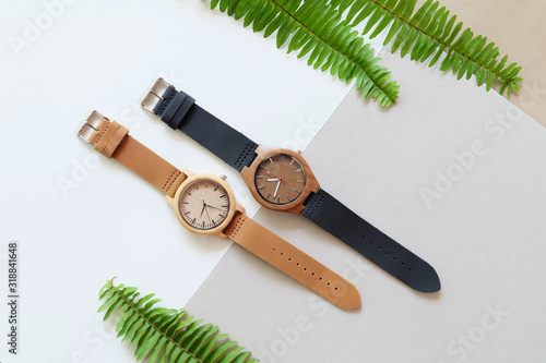 Brown and back wooden watches on white and soft brown color background