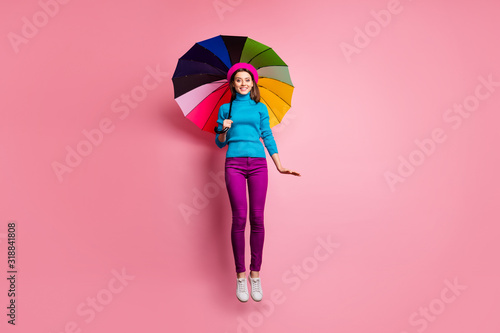 Full length photo of girlish charming girl jump have relax walk on rainy season fall weather hold bright umbrella wear good look outfit isolated over pink color background