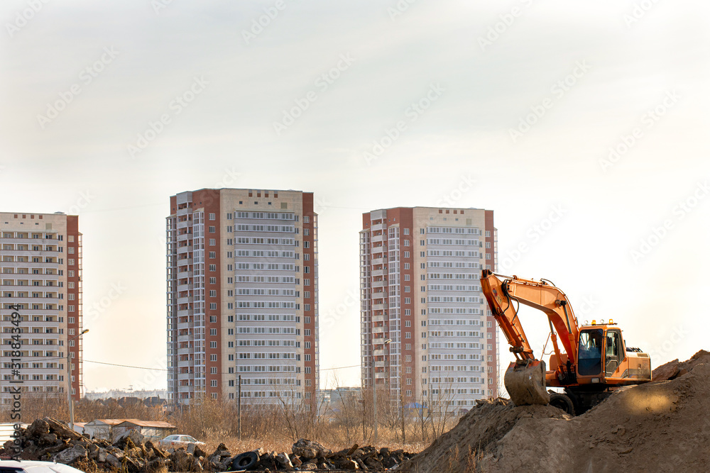 Construction machinery excavator at earthworks. Heavy earth mover Construction machinery excavator at earthworks. Heavy earth mover