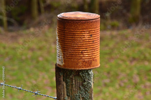boîte de conserve en métal rouillé, boîte de conserve rouillée sur un poteau