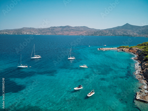 Beautiful landscape with blue lagoon and beach. Aerial shot of the Moni Eginas Island, Saronic gulf, Greece . A famous tourist destination.