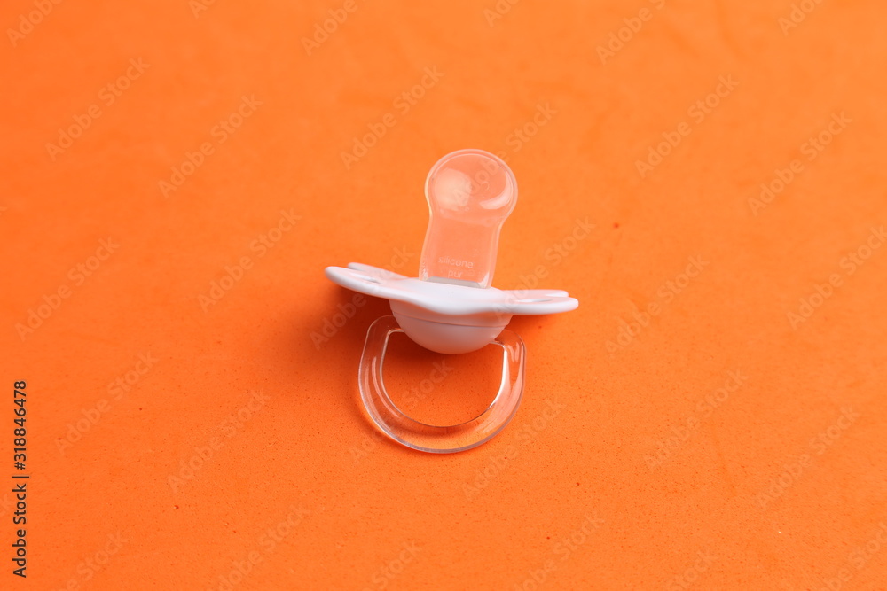 white pacifier in color background