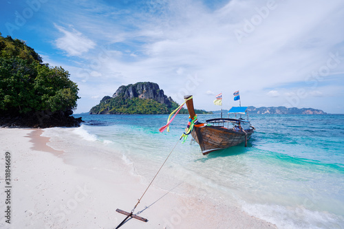 Beautiful landscape with traditional longtail boats, rocks, cliffs, tropical white sand beach. Traveling by Thailand. © luengo_ua
