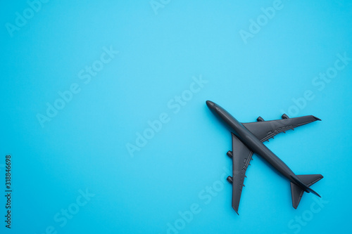 Travel concept Flat lay design with airplane on blue background with copy space.