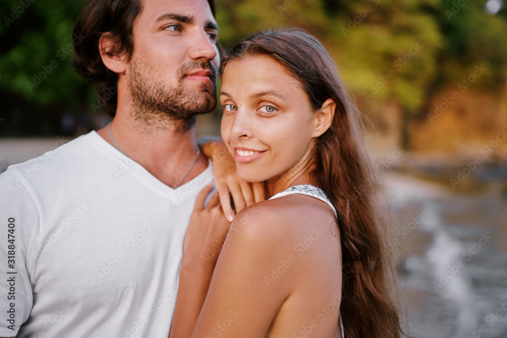 Love and romance. Honeymoon on the sea shore. Happy loving couple embracing on the beach. Love and romance. Honeymoon on the sea shore. Happy loving couple embracing on the beach.