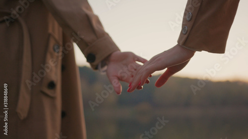 Canvas-taulu Female hands of young women holding separating at beautiful autumn sunset outdoor