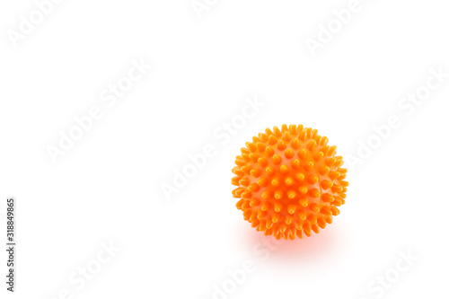 Orange plastic ball with spikes for washing in the washing machine. White background