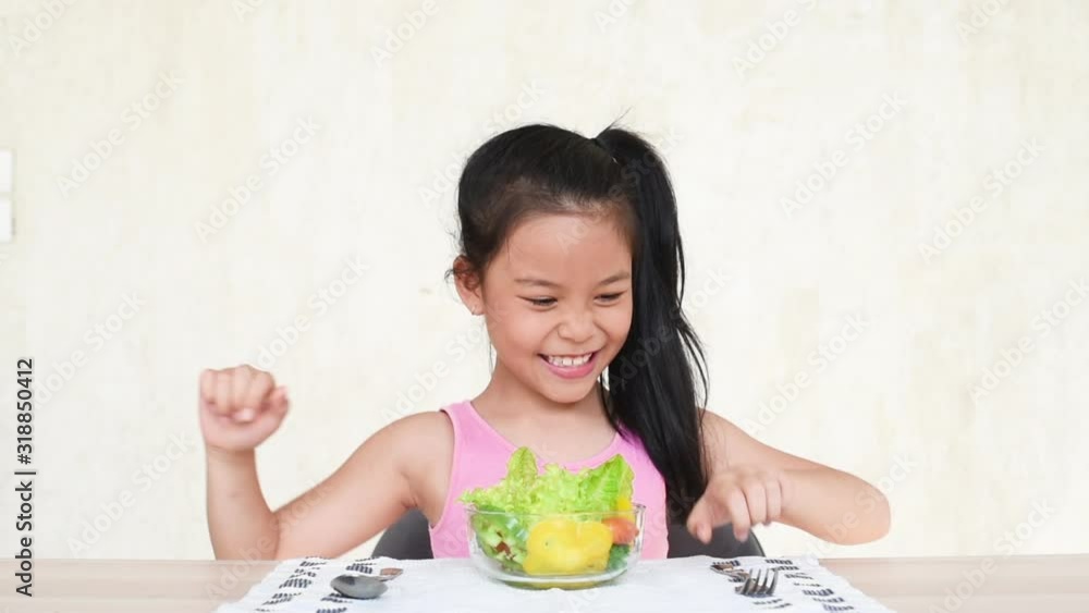 little asia girl enjoy eating with vegetable salad at home.eating vegetables by child make them healthier.having fun with food vegetables.enjoying vegetarian meal at festive desk.healthy food concept little asia girl enjoy eating with vegetable salad at home.eating vegetables by child make them healthier.having fun with food vegetables.enjoying vegetarian meal at festive desk.healthy food concept