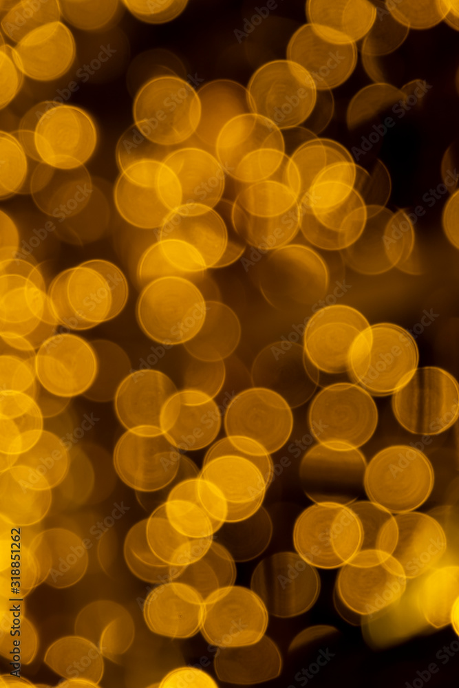 Defocused of blurred golden bokeh circle light from lighting bulb in the night for abstract background texture Defocused of blurred golden bokeh circle light from lighting bulb in the night for abstract background texture
