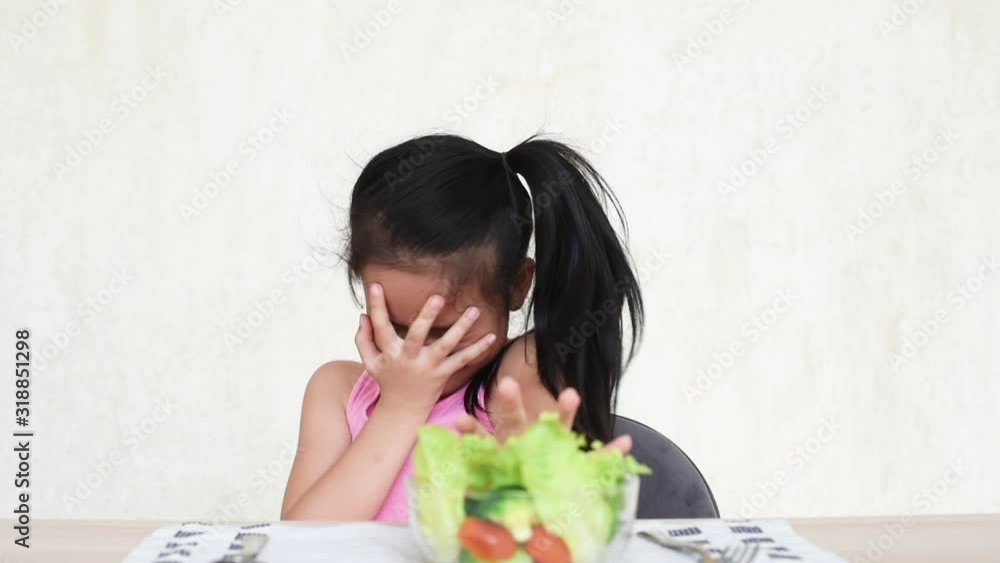 little asian girl do not want to eat vegetables and dislike taste of ...