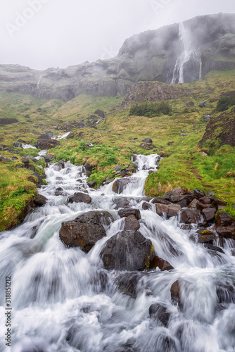 Bjarnarfoss waterfall at the western end of the Snaefellsnes peninsula, Iceland. Amazing dramatic landscape, harsh scandinavian nature, outdoor travel background, vertical image