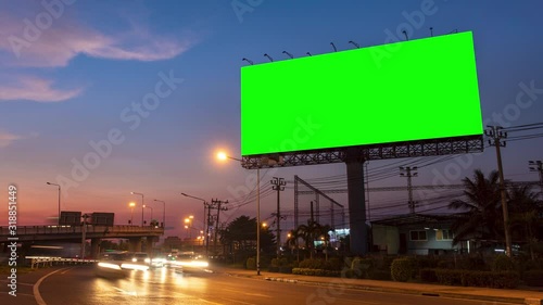 4k - Advertising billboard green screen on sidelines of expressway with traffic at evening, time lapse. photo