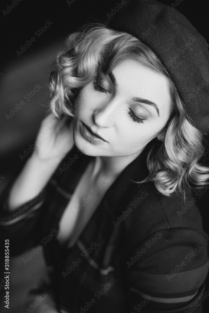 Beautiful blonde woman in a beret with closed eyes in retro style black and white photo. Close-up portrait. Soft focus. Beautiful blonde woman in a beret with closed eyes in retro style black and white photo. Close-up portrait. Soft focus.