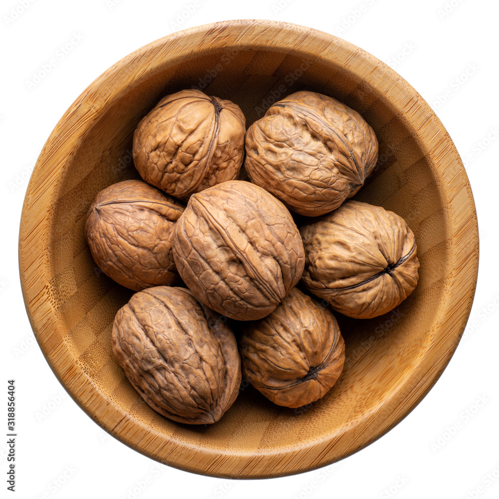 Unpeeled walnuts in a round wooden bowl Unpeeled walnuts in a round wooden bowl