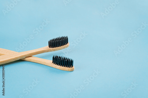 Two bamboo toothbrushes on bluw background. Eco friendly lifestyle