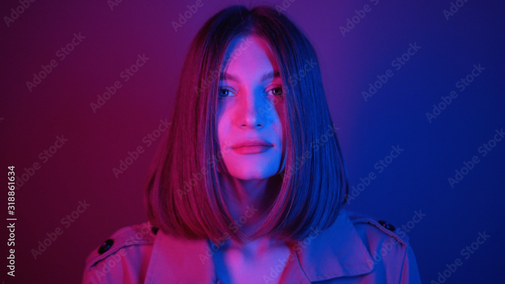 Seductive young woman with straight hair looking at camera, dancing. Magical power of femininity.Charismatic. Neon lighting. Shooting, footage. Style, fashion Seductive young woman with straight hair looking at camera, dancing. Magical power of femininity.Charismatic. Neon lighting. Shooting, footage. Style, fashion