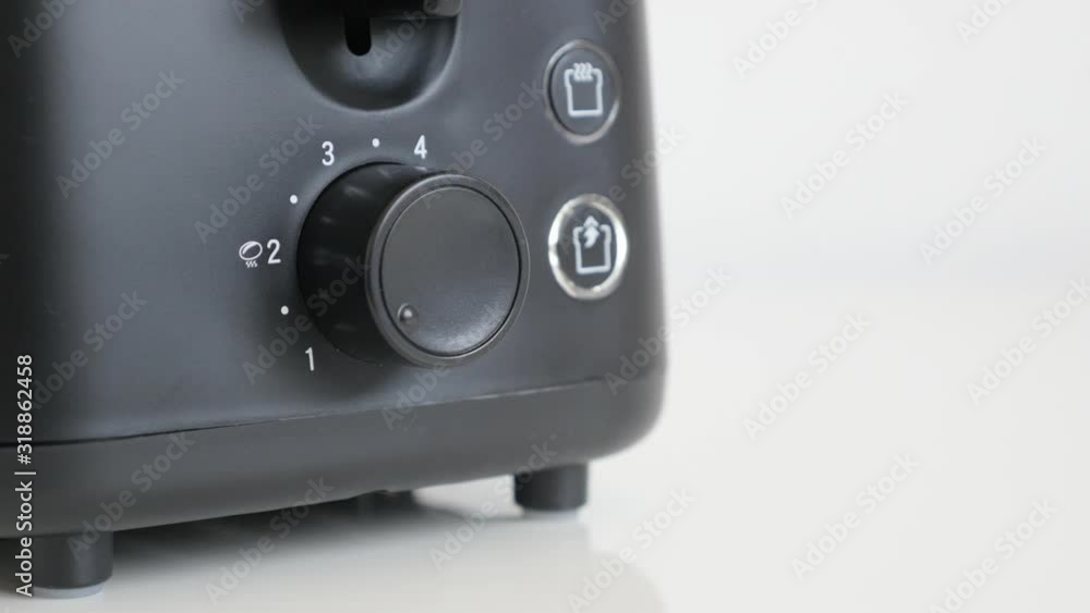 Starting toasting of bread with lowering leveler 4K video Starting toasting of bread with lowering leveler 4K video