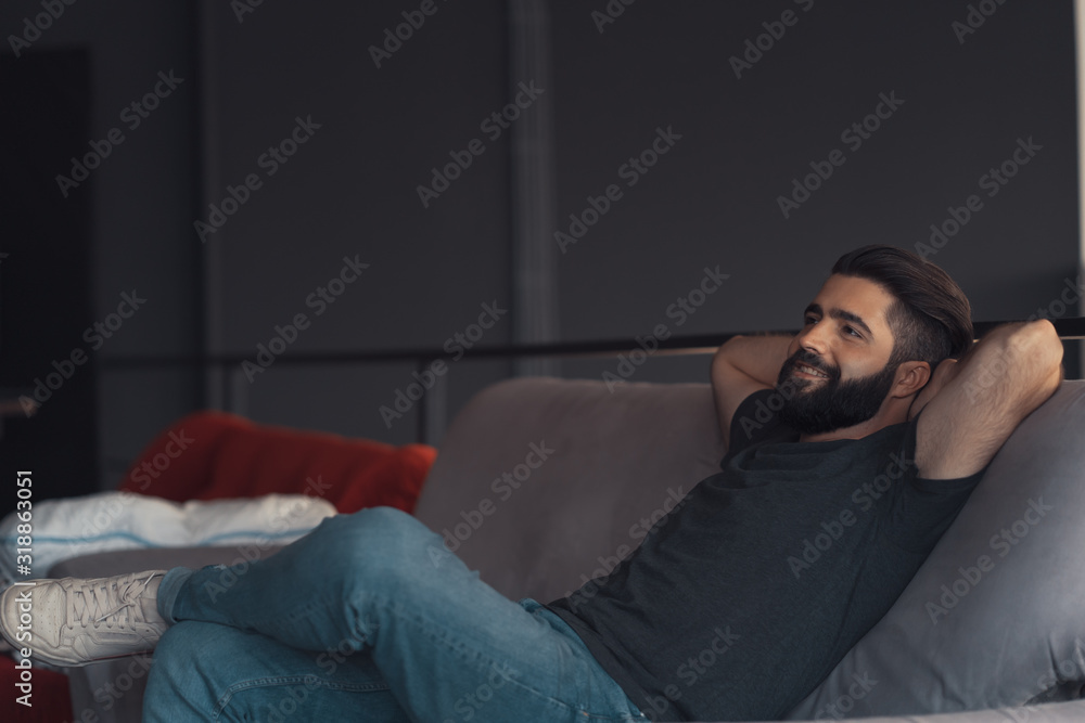 Young man sitting relaxing on the couch Young man sitting relaxing on the couch