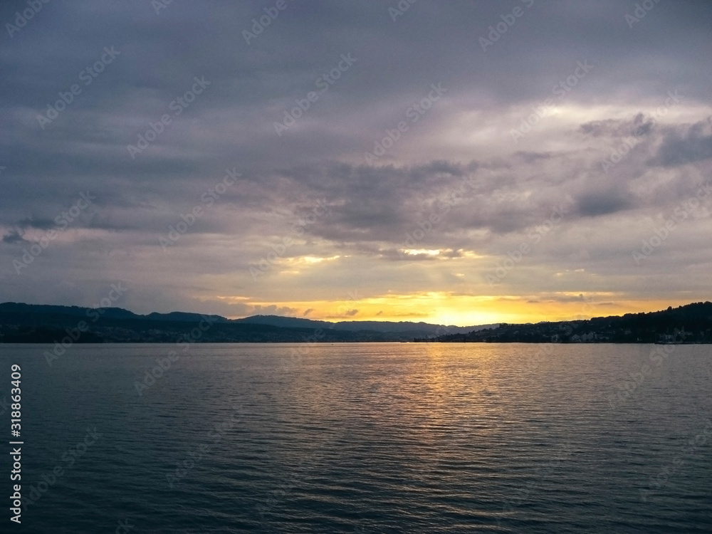 Beautiful sunset at Lake Zurich with sun reflecting from water. Beautiful sunset at Lake Zurich with sun reflecting from water.