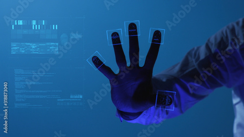 The person clicks on the fingerprint scanner, which is executed in the style of the digital future. The digital world and technology. Security scanning of digital programs and fingerprint biometrics