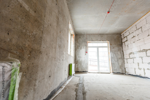 Empty room before repair. Gray walls unfinished