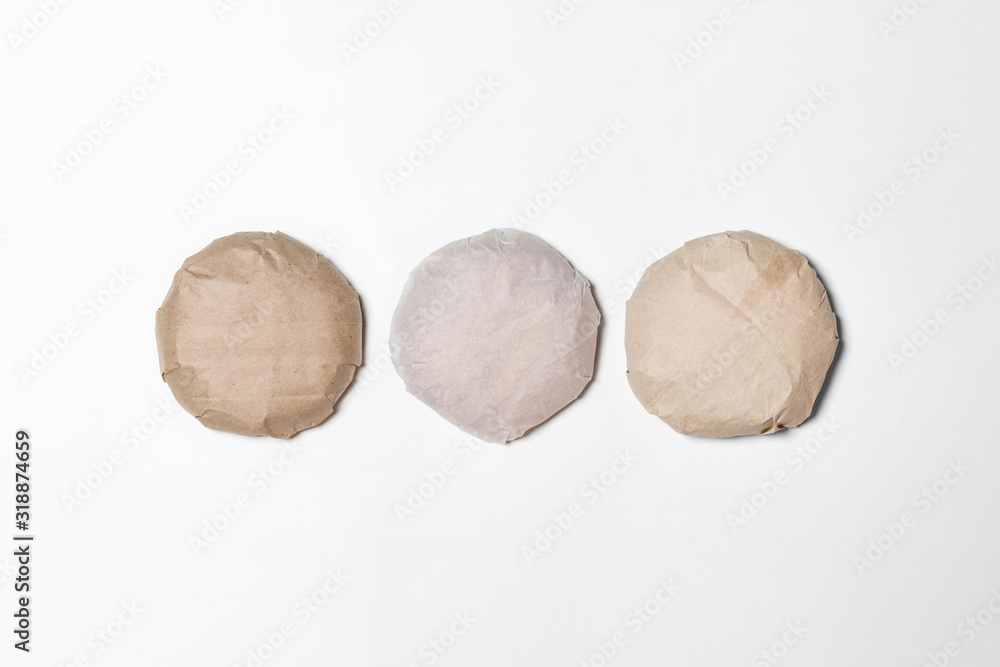 Classic Burgers packed in the wrapping paper on white background. Top