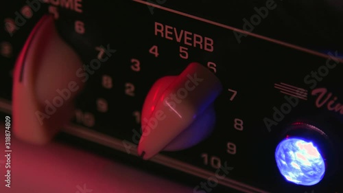 Close up of Hand Moving Reverb of Guitar Amplifier photo