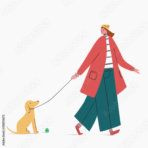 Woman walking dog with ball