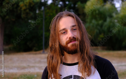 Photos Portrait of handsome bearded young man with long hair